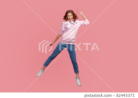 Portrait of young emotional woman on pink background. 82443371