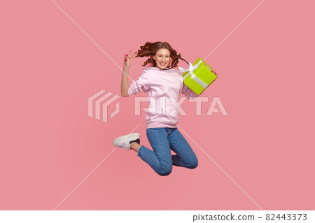 Portrait of young emotional woman on pink background. 82443373