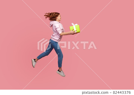Portrait of young emotional woman on pink background. 82443376