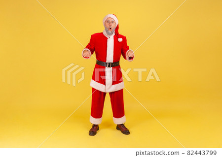 Emotional aged santa clause on yellow background. Emotional aged santa clause on yellow background. 82443799
