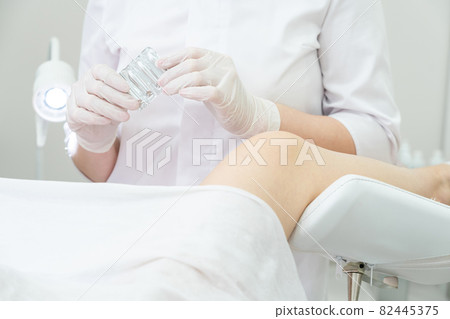 Gynecologist holding vaginal suppositories consulting patient in medical chair Gynecologist holding vaginal suppositories consulting patient in medical chair 82445375