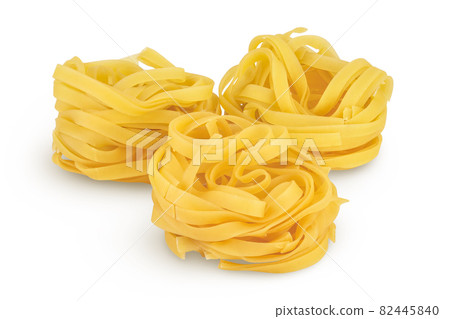 Raw tagliatelle pasta isolated on white background with clipping path and full depth of field Raw tagliatelle pasta isolated on white background with clipping path and full depth of field 82445840