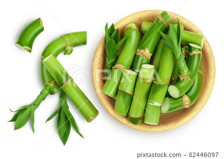 Green bamboo in wooden bowl isolated on white background with clipping path and full depth of field. Top view. Flat lay Green bamboo in wooden bowl isolated on white background with clipping path and full depth of field. Top view. Flat lay 82446097