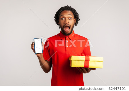 Portrait of young emotional african man on gray background. Portrait of young emotional african man on gray background. 82447101
