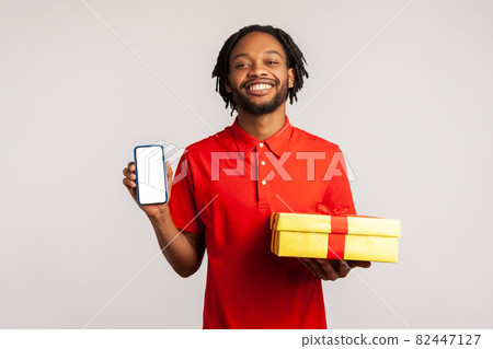 Portrait of young emotional african man on gray background. Portrait of young emotional african man on gray background. 82447127