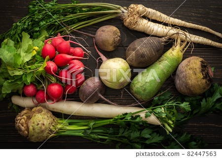 Root vegetables on a wooden background Root vegetables on a wooden background 82447563