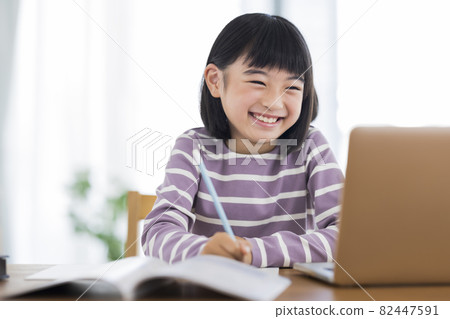 Girls studying while looking at a computer Online class Girls studying while looking at a computer Online class 82447591