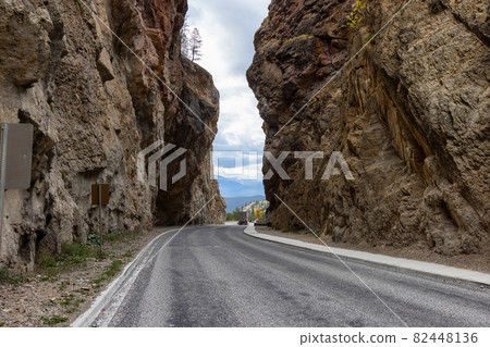 Scenic Road in the rocky canyon cliffs by Canadian Mountains. 82448136