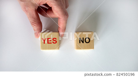 Hand making a choice between two cubes with Yes and No on white background. Business concept. Copy space. Hand making a choice between two cubes with Yes and No on white background. Business concept. Copy space. 82450196