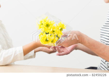 Grandchildren and grandmother presenting flowers 82450226