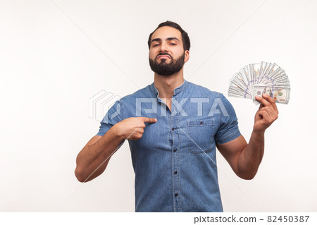 Emotional young bearded man on gray background. 82450387