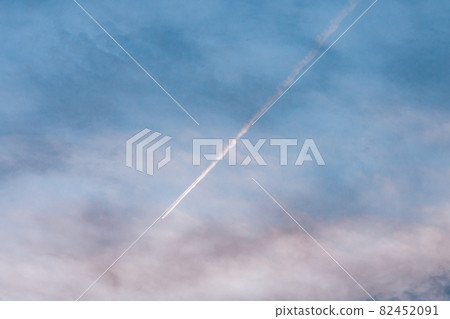 Contrails over the sunset sky Contrails over the sunset sky 82452091