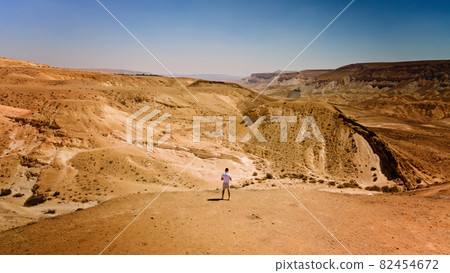 lonely man walking in the desert israel  82454672