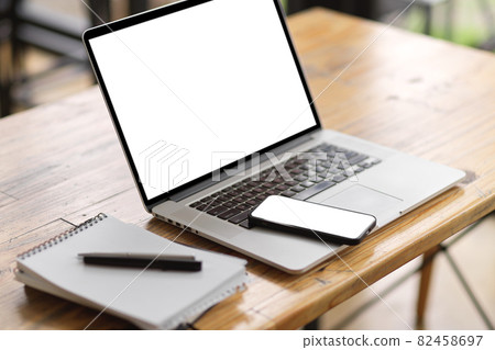 Workspace with laptop blank screen mockup, smart mobile phone and supplies 82458697