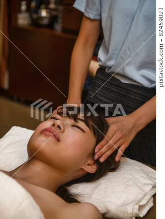 Young woman receiving a massage at an esthetic cut Young woman receiving a massage at an esthetic cut 82459021