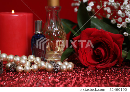 Candle and Rose With Perfume on Red Velvet Background Candle and Rose With Perfume on Red Velvet Background 82460190