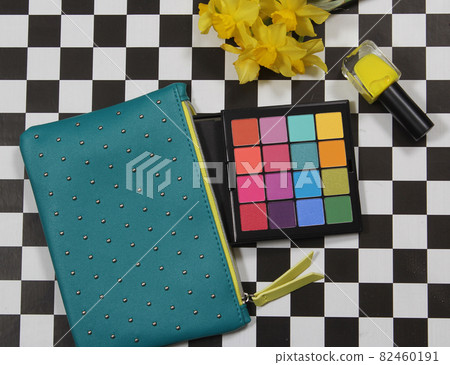 Cosmetics and Yellow Flowers on Checkerboard Background Cosmetics and Yellow Flowers on Checkerboard Background 82460191