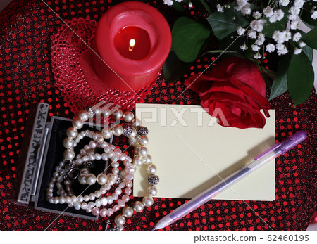 Rose and Candle With Pearls on Red Velvet Background Rose and Candle With Pearls on Red Velvet Background 82460195