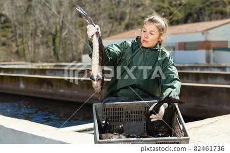 Proud female fish farm owner with sturgeons 82461736