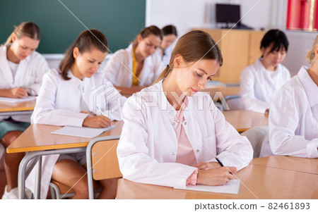 Medical students writing in notepads 82461893