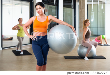Woman with fitness ball Woman with fitness ball 82462276