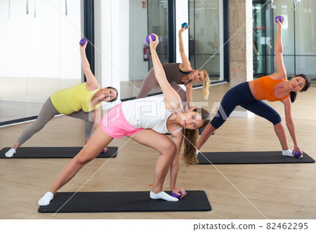 Women practicing pilates with balls at group class in yoga studio Women practicing pilates with balls at group class in yoga studio 82462295