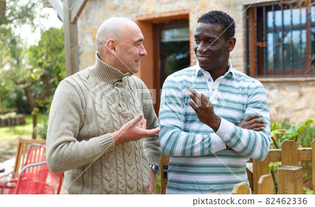 Good neighbors talk on the border of their farms Good neighbors talk on the border of their farms 82462336