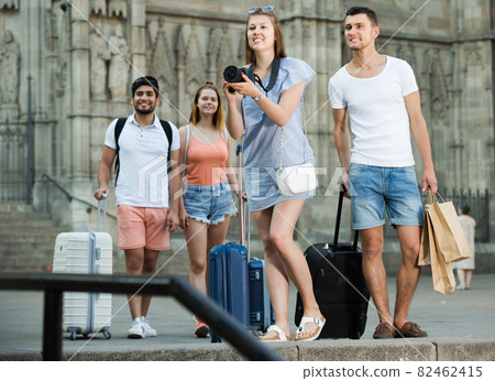 Two people taking picture with camera in town Two people taking picture with camera in town 82462415
