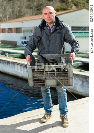 Owner of fish farm with sturgeons Owner of fish farm with sturgeons 82463861