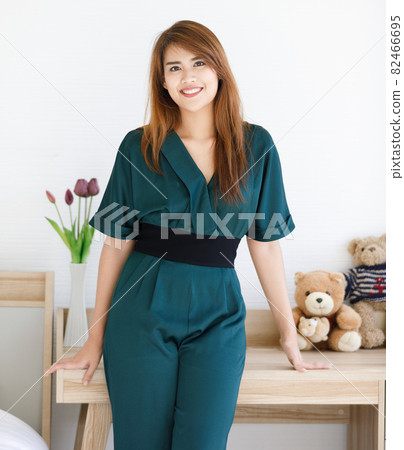 Young and beaufiful Asian woman standing with wild smile happy face in bedroom 82466695