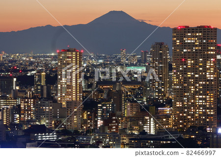 View of Mt. Fuji as seen from central Tokyo Japan showing the city with the sun setting behind Fuji-san 82466997