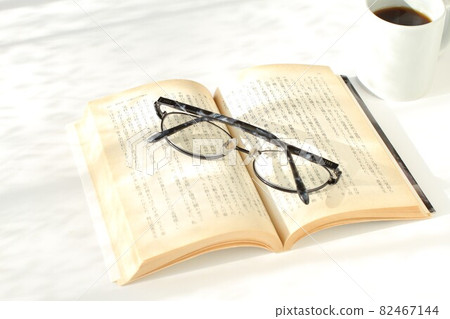 Books in the sun, glasses, coffee, white background 82467144