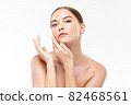 Caucasian woman with smooth fresh glowing skin touching face for beauty and skincare concepts 82468561