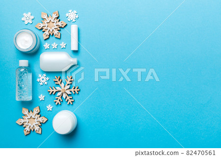 Makeup products and Christmas decorations on color background. Top view New year Beauty concept with copy space 82470561