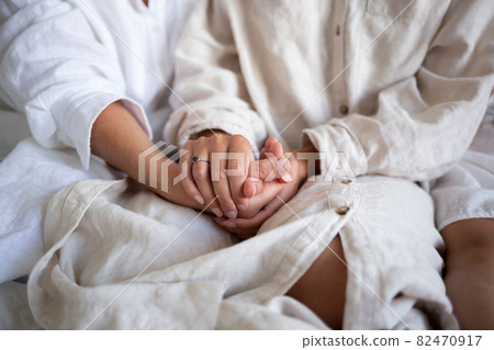 close-up shot: a young woman holds her mother's arms in her arms 82470917