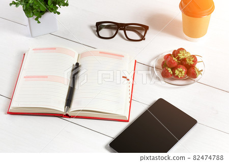 Stylish minimalistic workplace with tablet and notebook and glasses in flat lay style. White background. 82474788