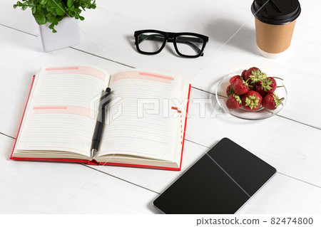 Stylish minimalistic workplace with tablet and notebook and glasses in flat lay style. White background. Stylish minimalistic workplace with tablet and notebook and glasses in flat lay style. White background. 82474800