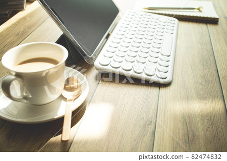 Image of coffee and telecommuting on wooden desk 82474832