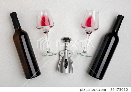 Glasses and bottles of red and white wine on white background from top view Glasses and bottles of red and white wine on white background from top view 82475010