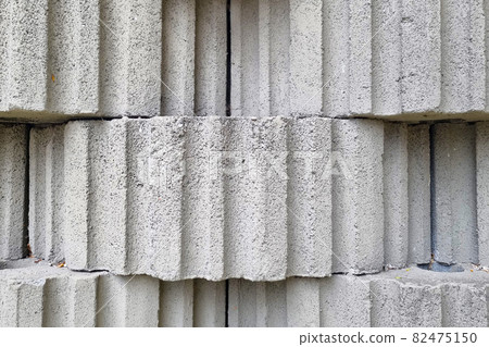 A view of the gray concrete texture of a building or structure. 82475150