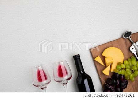 Two glasses of red wine, cheese and grapes. Top view Two glasses of red wine, cheese and grapes. Top view 82475261