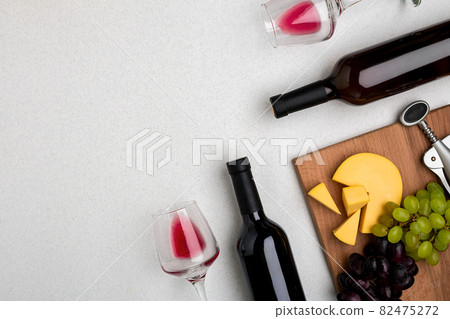Two glasses of red wine, cheese and grapes. Top view 82475272