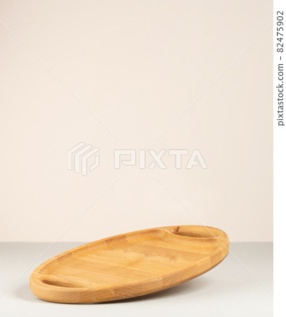 empty brown wooden kitchen board on gray paper background, utensils 82475902