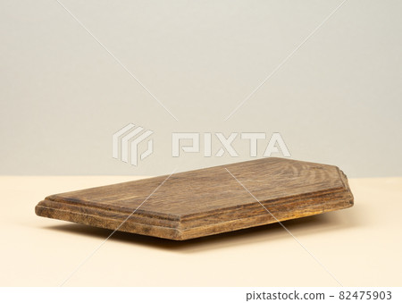 rectangular empty brown wooden kitchen board on yellow background, utensils 82475903
