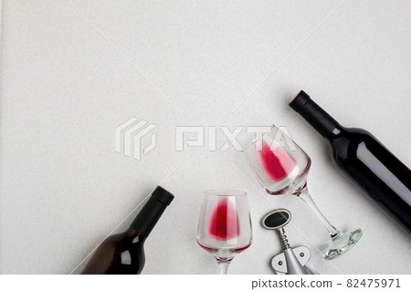 Glasses and bottles of red and white wine on white background from top view Glasses and bottles of red and white wine on white background from top view 82475971