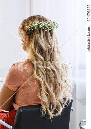 Women's festive hairstyle. Long female curls. Back view. 82476325