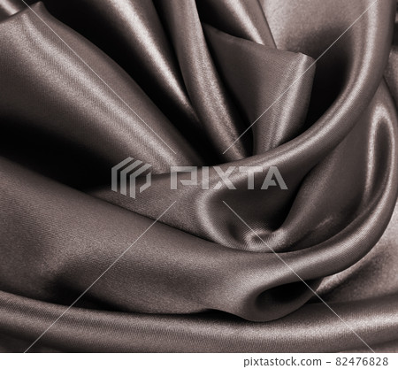 Smooth elegant brown silk or satin texture as abstract background. Luxurious background design. In Sepia toned. Retro style 82476828