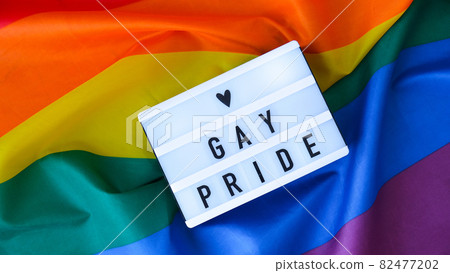 Rainbow flag with lightbox and text GAY PRIDE. Rainbow lgbtq flag made from silk material. Symbol of LGBTQ pride month. Equal rights. Peace and freedom Rainbow flag with lightbox and text GAY PRIDE. Rainbow lgbtq flag made from silk material. Symbol of LGBTQ pride month. Equal rights. Peace and freedom 82477202