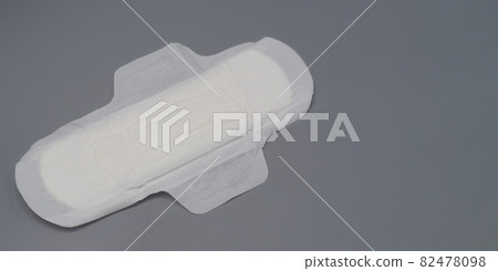 Woman trying to earing sanitary napkins or menstruation pad with