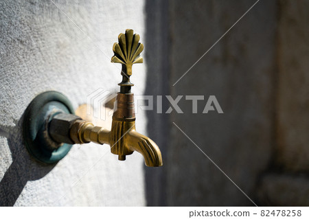 closeup of vintage bronze water faucet 82478258